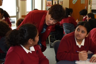 An image of Dame Patsy Reddy with students of St Anne's School