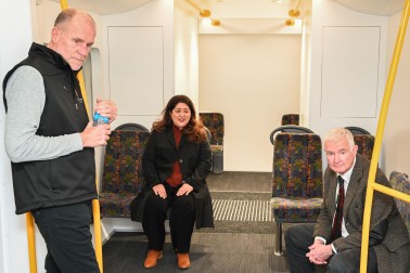 Dame Cindy and Dr Davies on the mock train carriage with Mr John Mulka