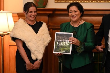 Nicola Toki presenting Forest and Bird's centennial publication to Dame Cindy