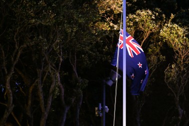 The New Zealand Flag being lowered during the Commemoration