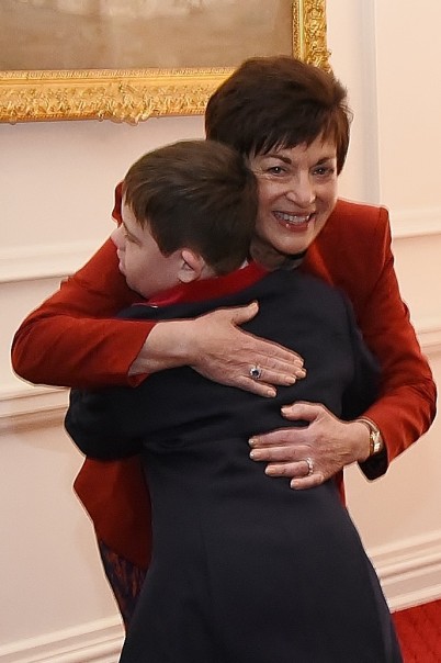 Image of Dame Patsy receiving a hug from Frances Clarke Award recipient, Fletch Gallagher 