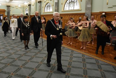 an image of The Herald of Arms Extraordinary leading Dame Patsy and Sir David into the Grand Hall