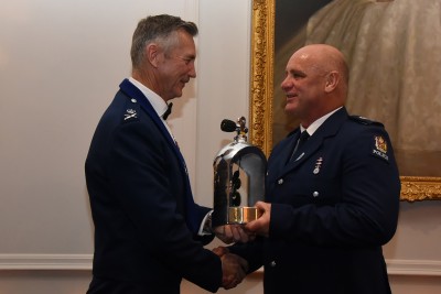 an image of Police Commissioner Mike Bush presenting a taonga to Senior Sergeant Bruce Adams