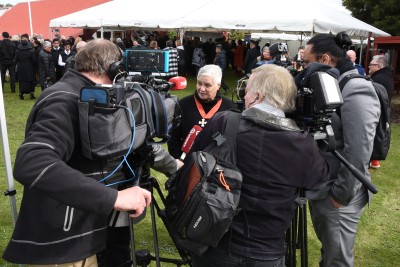 Image of Dame Tariana being interviewed by the media