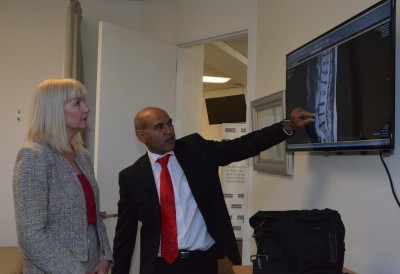 Dr Kiresh Kanji talks about spinal issues with Lady Janine.